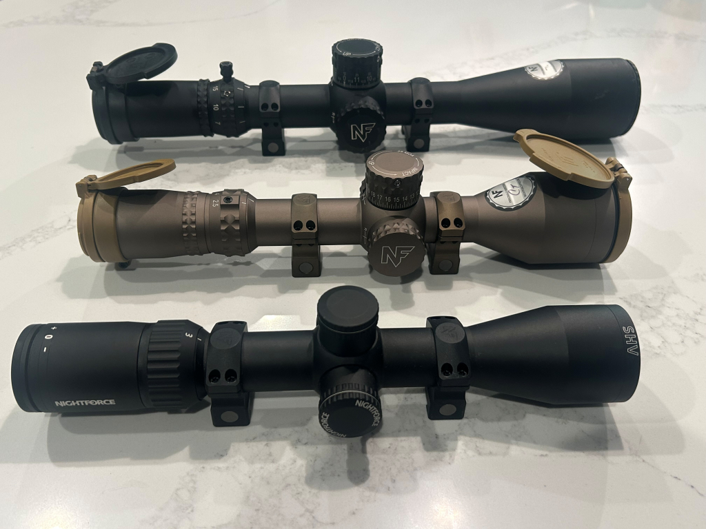 Three modern riflescopes shown side by side, illustrating examples of optics used to compare first focal plane and second focal plane reticle systems.