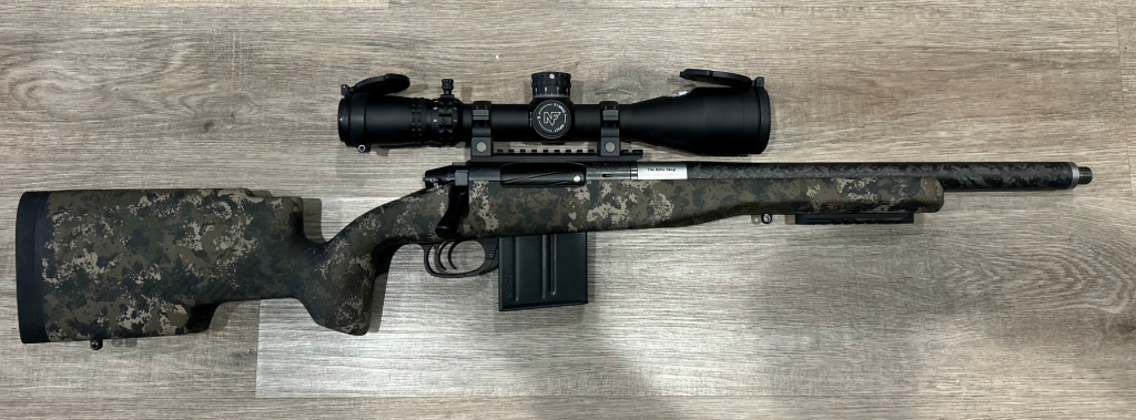 Precision hunting rifle with scope, bipod, and detachable magazine