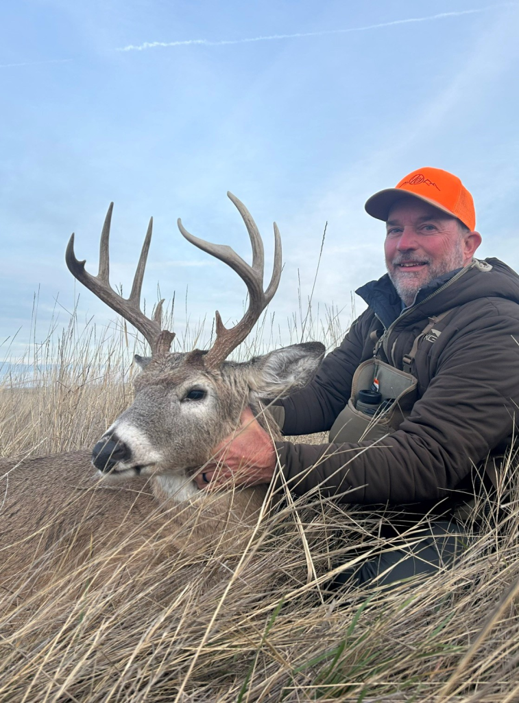 Hunter with a whitetail buck taken in South Dakota