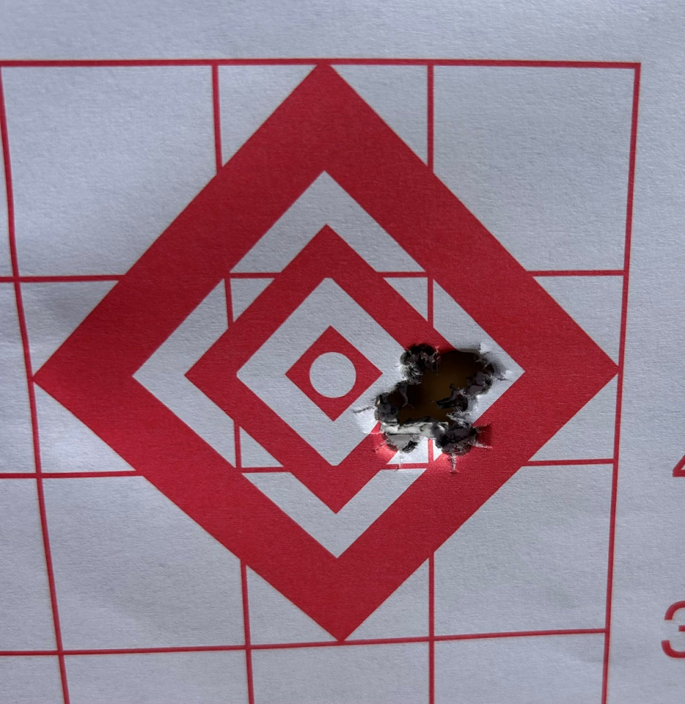 Paper target showing a rifle group used to establish and confirm zero
